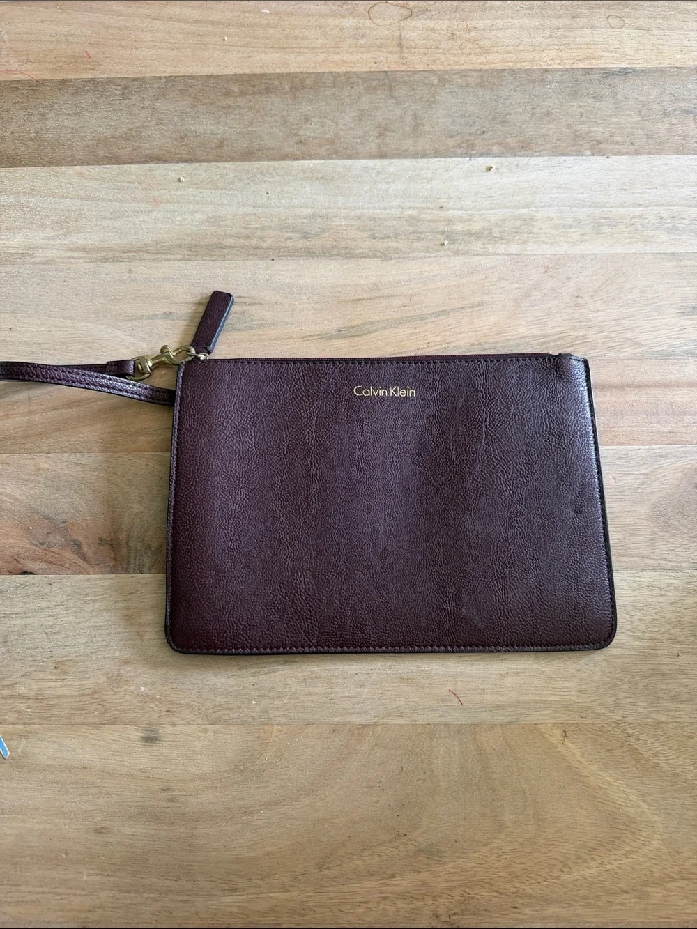Calvin Klein Dark Brown almost maroon like Leather Wristlet Pouch with Gold Logo